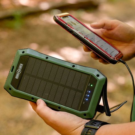 A green smartphone with a detachable accessory attached to its back.