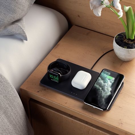 Black device with a circular pad and cable, partially opened.